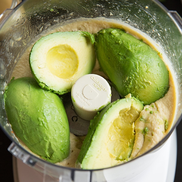A process shot of making avocado hummus