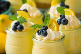 Lemon mousse in glass jars with whipped cream
