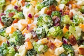 A close up of a broccoli and cauliflower salad in a bowl