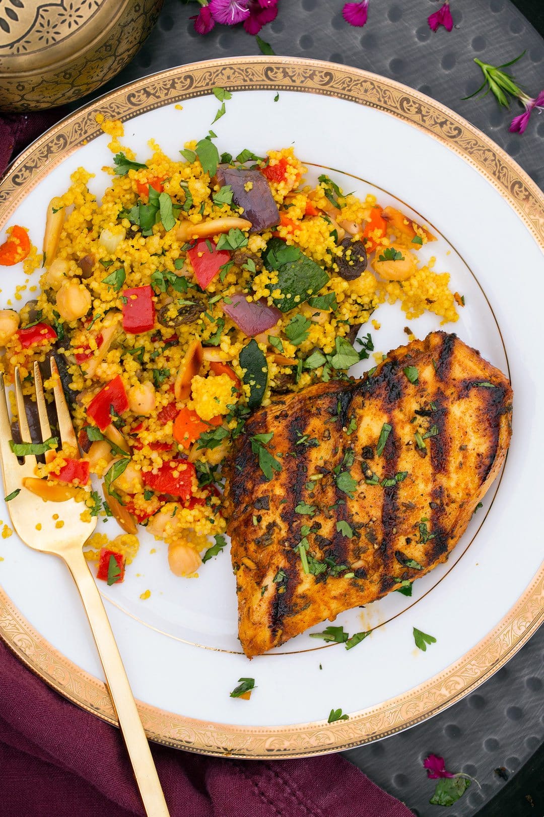 Couscous served on a a white plate with chicken.