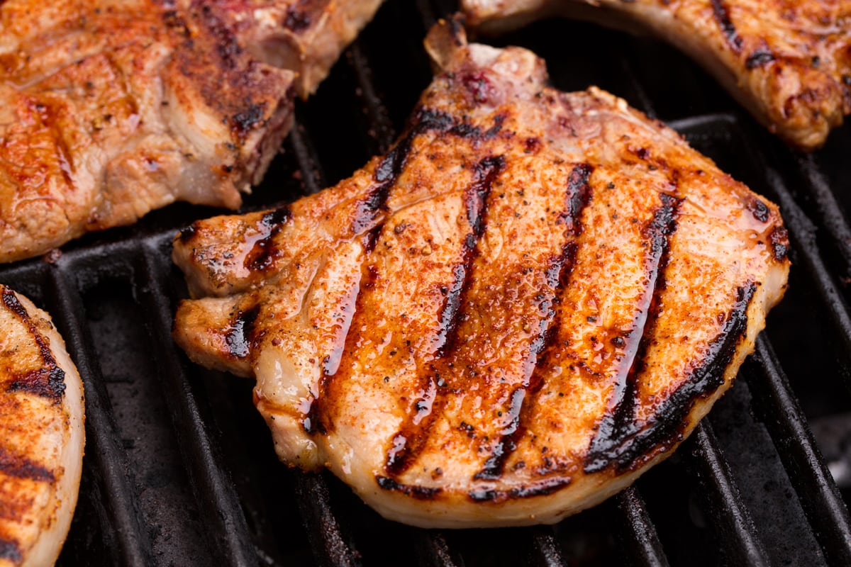 Close up image of pork chop on grill.