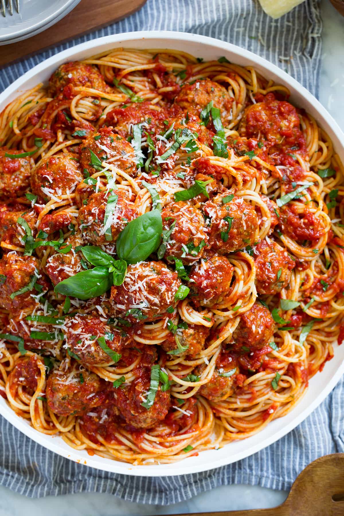 Serving platter with tall stack of homemade spaghetti and meatballs.