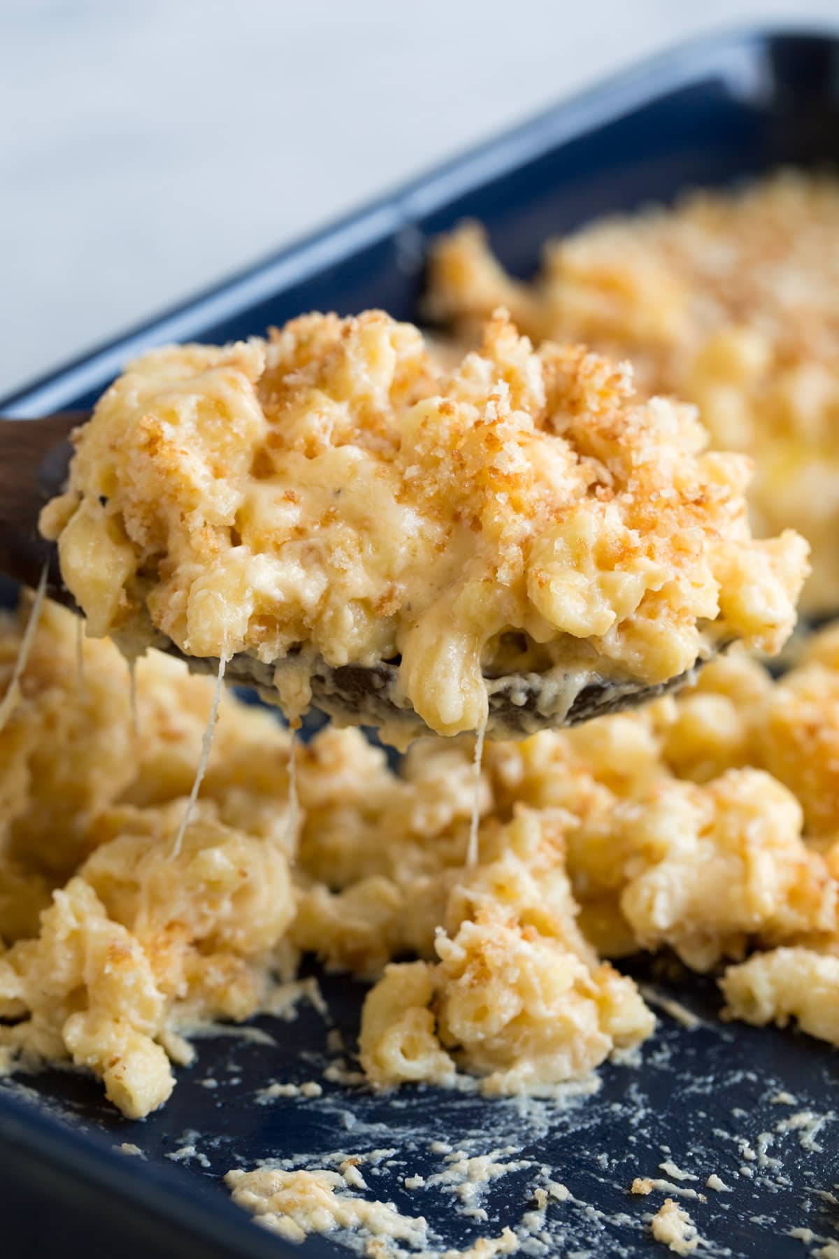 Scoop full of baked macaroni and cheese.