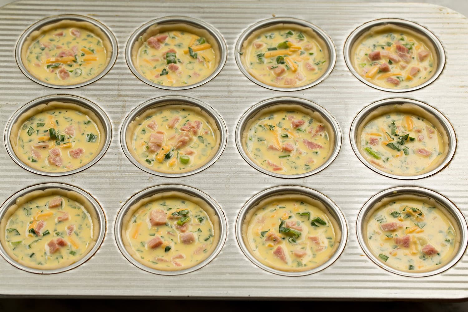 Filled pie crusts in muffin pan.