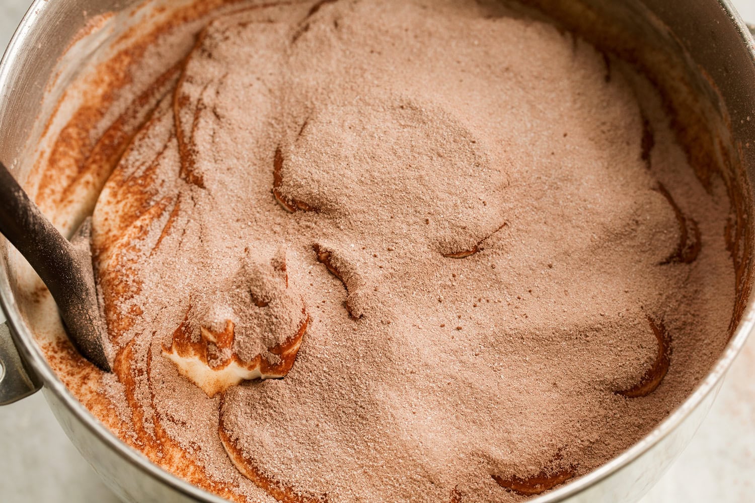 Flour cocoa mixture dusted over whipped egg white mixture.