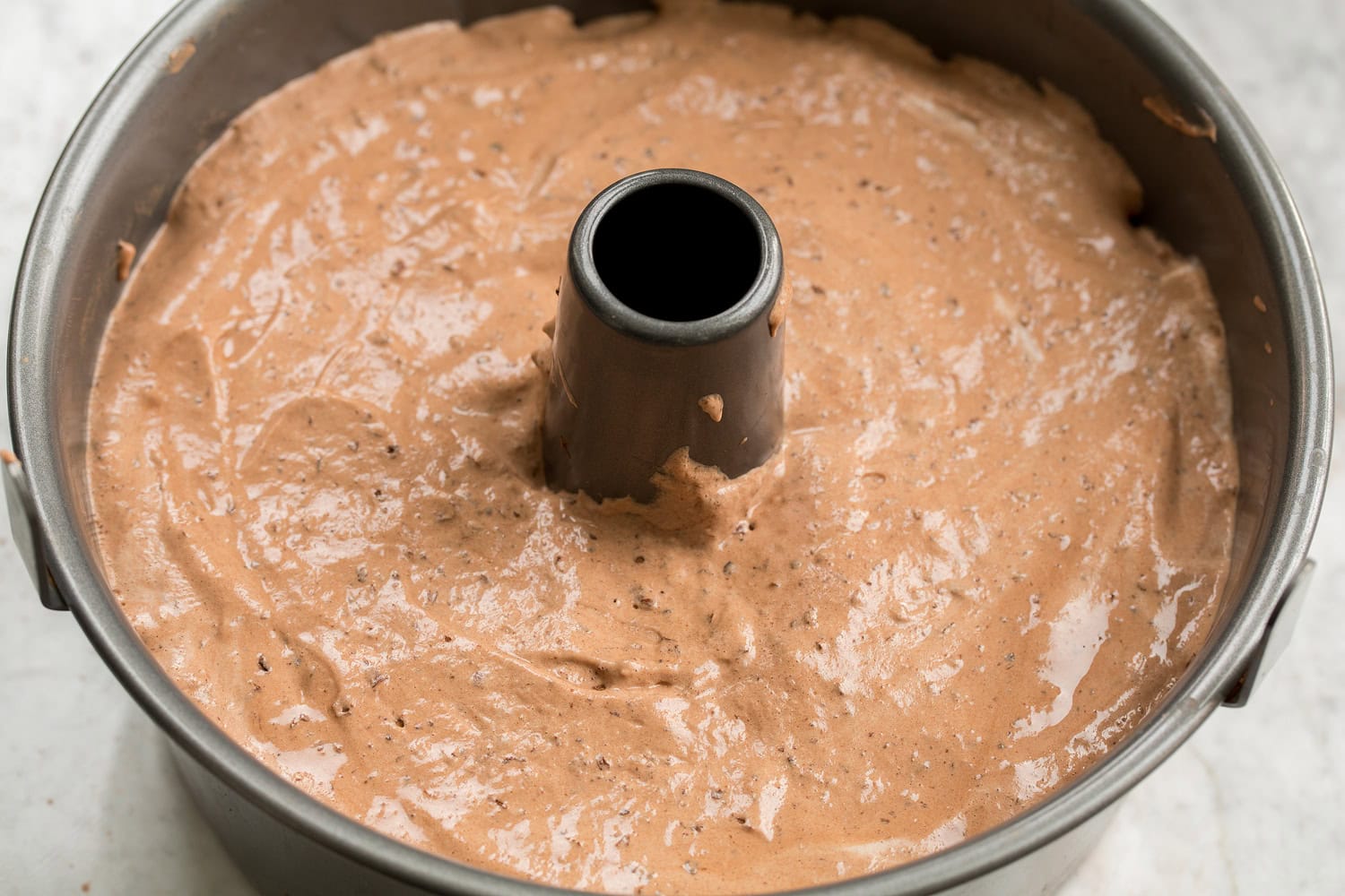 Chocolate angel food cake batter in pan shown before baking.
