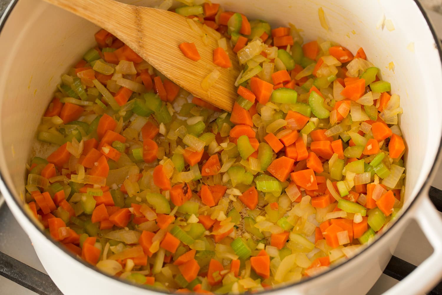 Veggies sauteed in a large pot.
