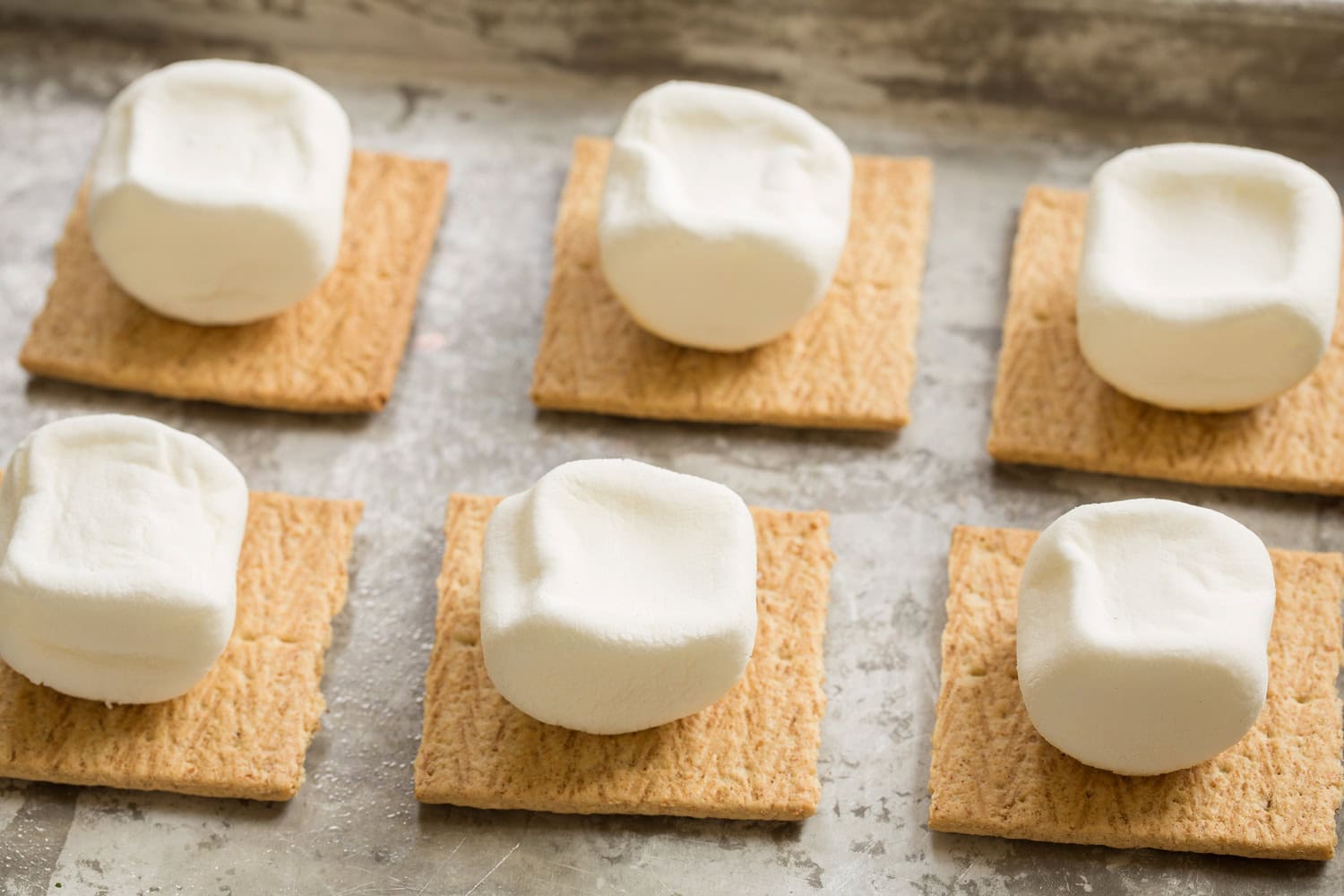 Marhsmallows turned over to untoasted side and set on a graham cracker to toast under broiler on second side.