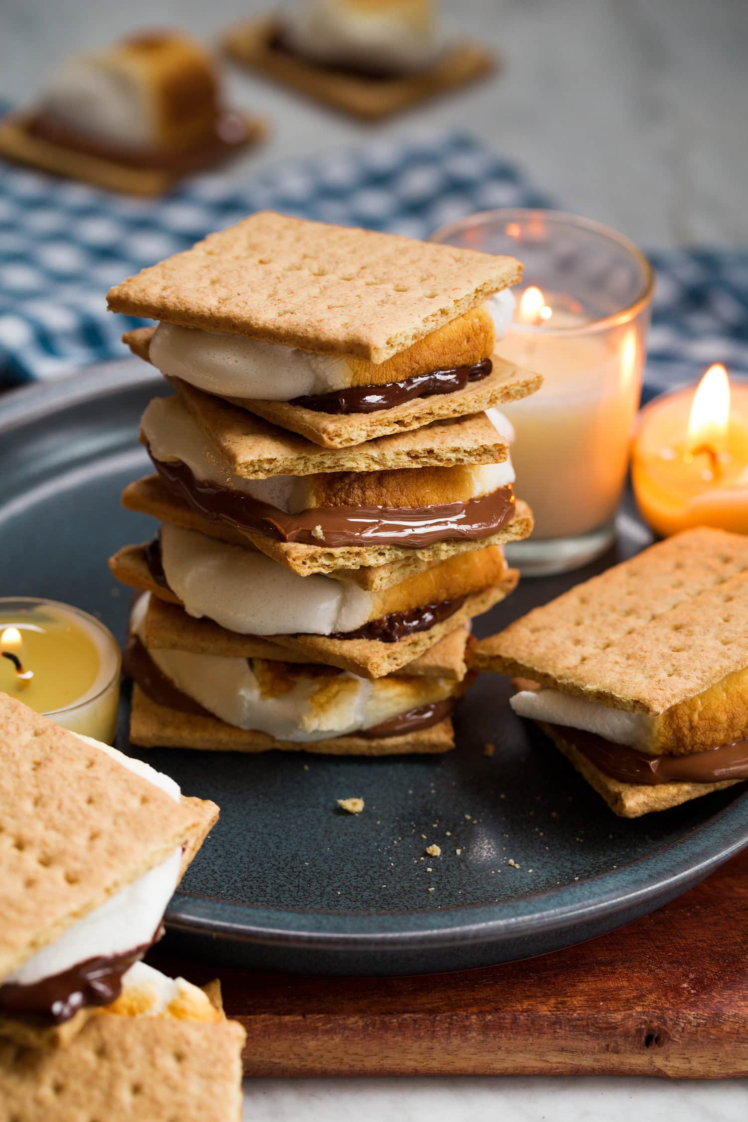 Stacked s'mores with candles to the side.